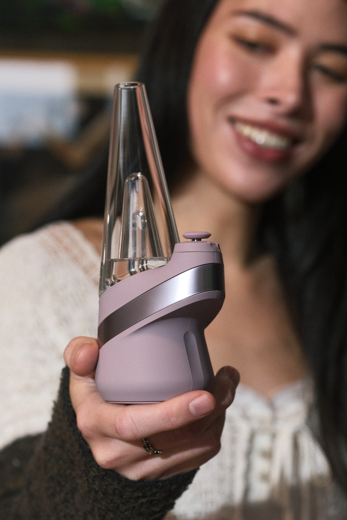 Woman holding the Puffco Peak in Bliss
