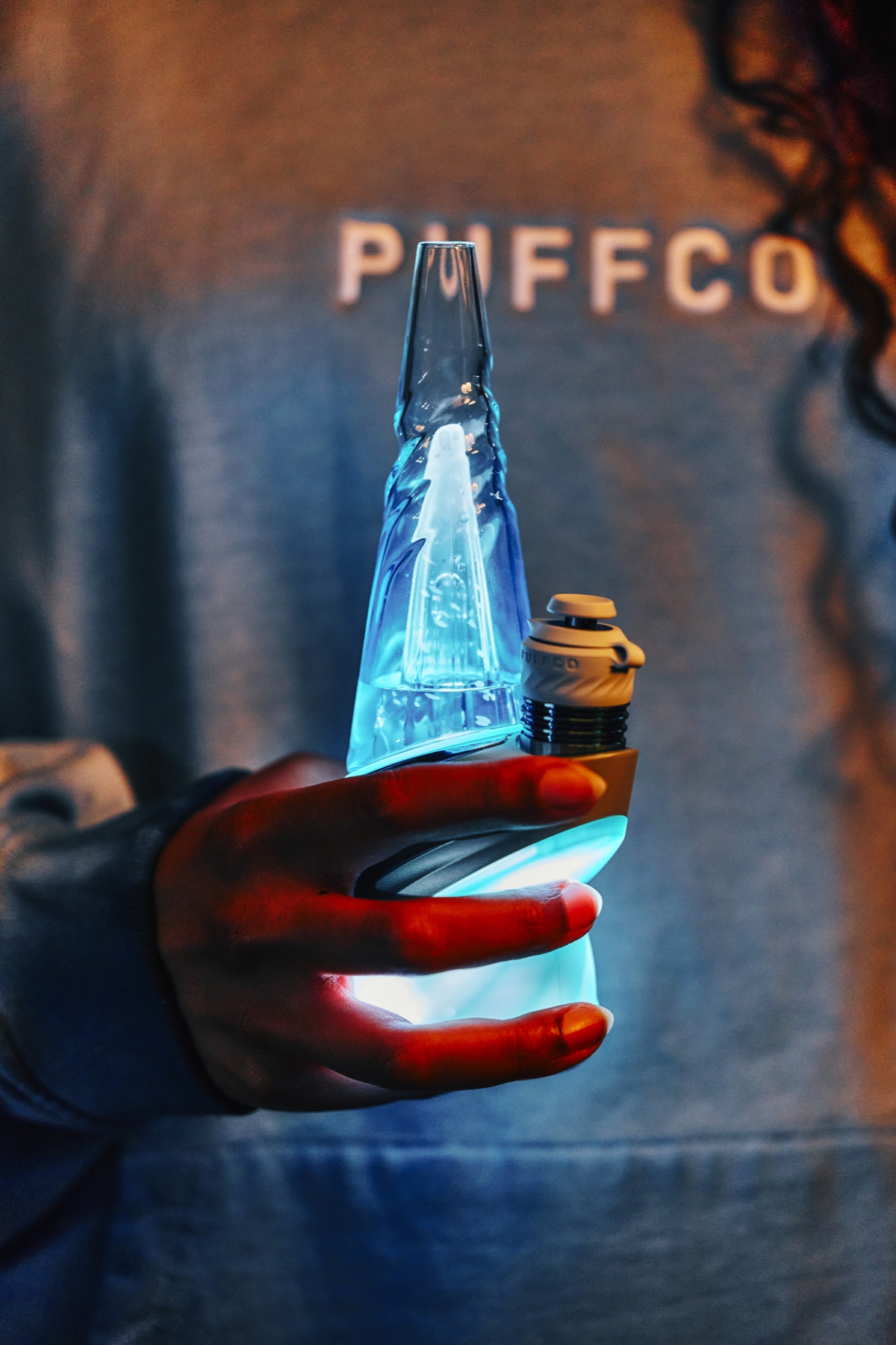 Puffco Peak Pro Glacier edition glowing blue in hand